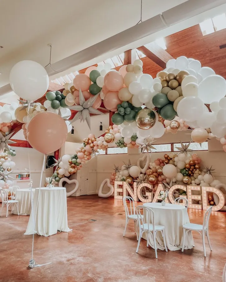 fun-carnival-engagement-party-ideas-and-themes-with-balloon-arch-and-simple-table-decorations